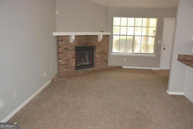 an empty room with a fireplace