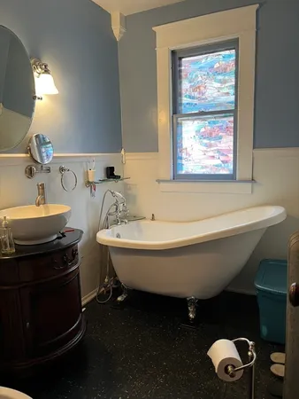 a living room with furniture a chandelier and a dining table