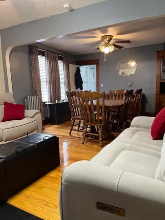 a living room with furniture and view of kitchen