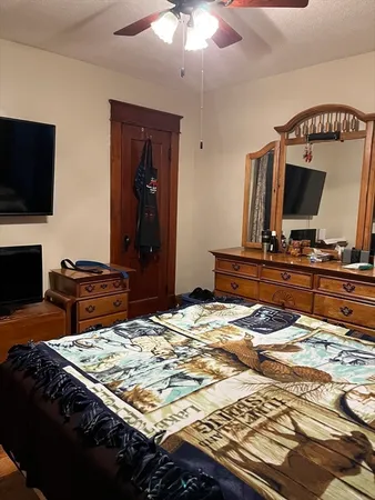 a bedroom with a bed and a flat screen tv