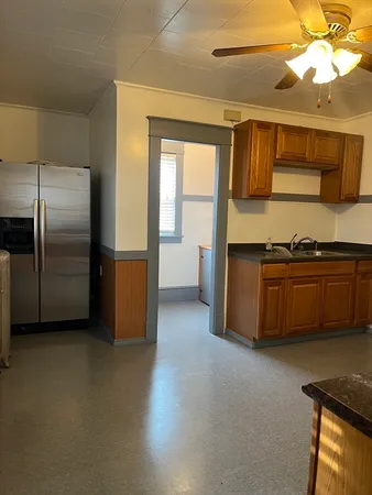 a kitchen with stainless steel appliances granite countertop a refrigerator and a sink