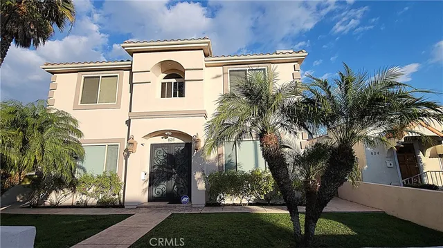 a front view of a house with a garden