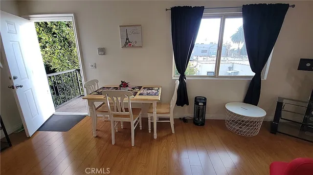 a bedroom with a bed and a wooden floor