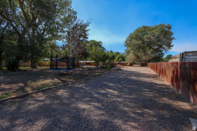 270 East 100 North Monroe, UT 84754 - Photo 35 of 65 Gravel drive with a reddish-brown wooden fence