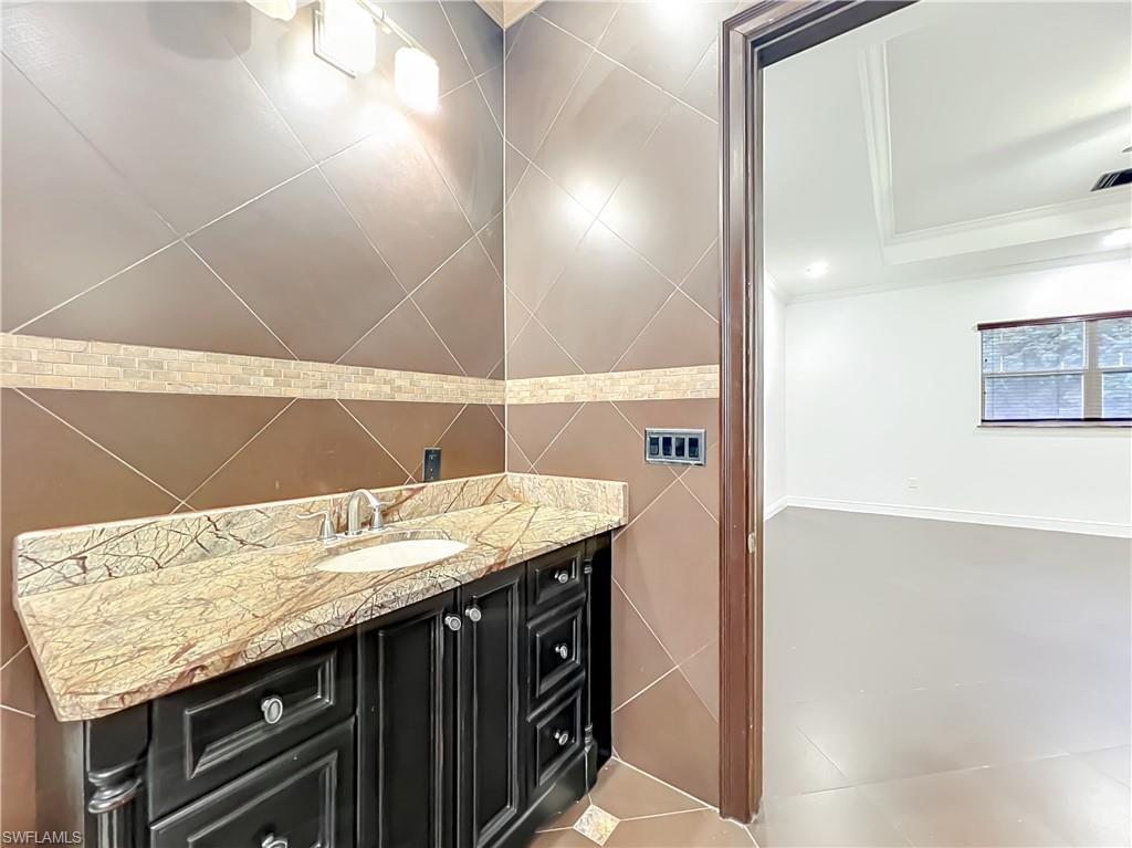 4200 South Hiawassee Road Orlando, FL 32835 - Photo 25 of 47 a bathroom with a granite countertop sink and a mirror