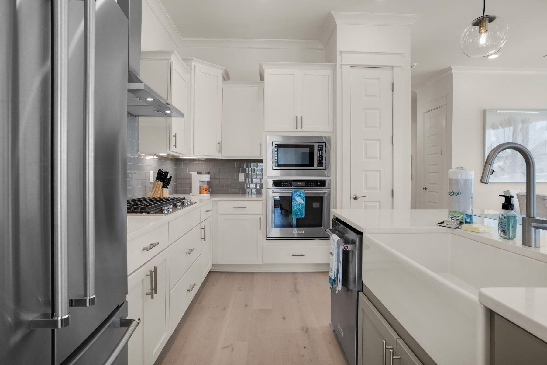 110 Wharf Ln Inlet Beach, Unit A Inlet Beach, FL 32461 - Photo 12 of 27 a kitchen with granite countertop a sink stainless steel appliances and white cabinets