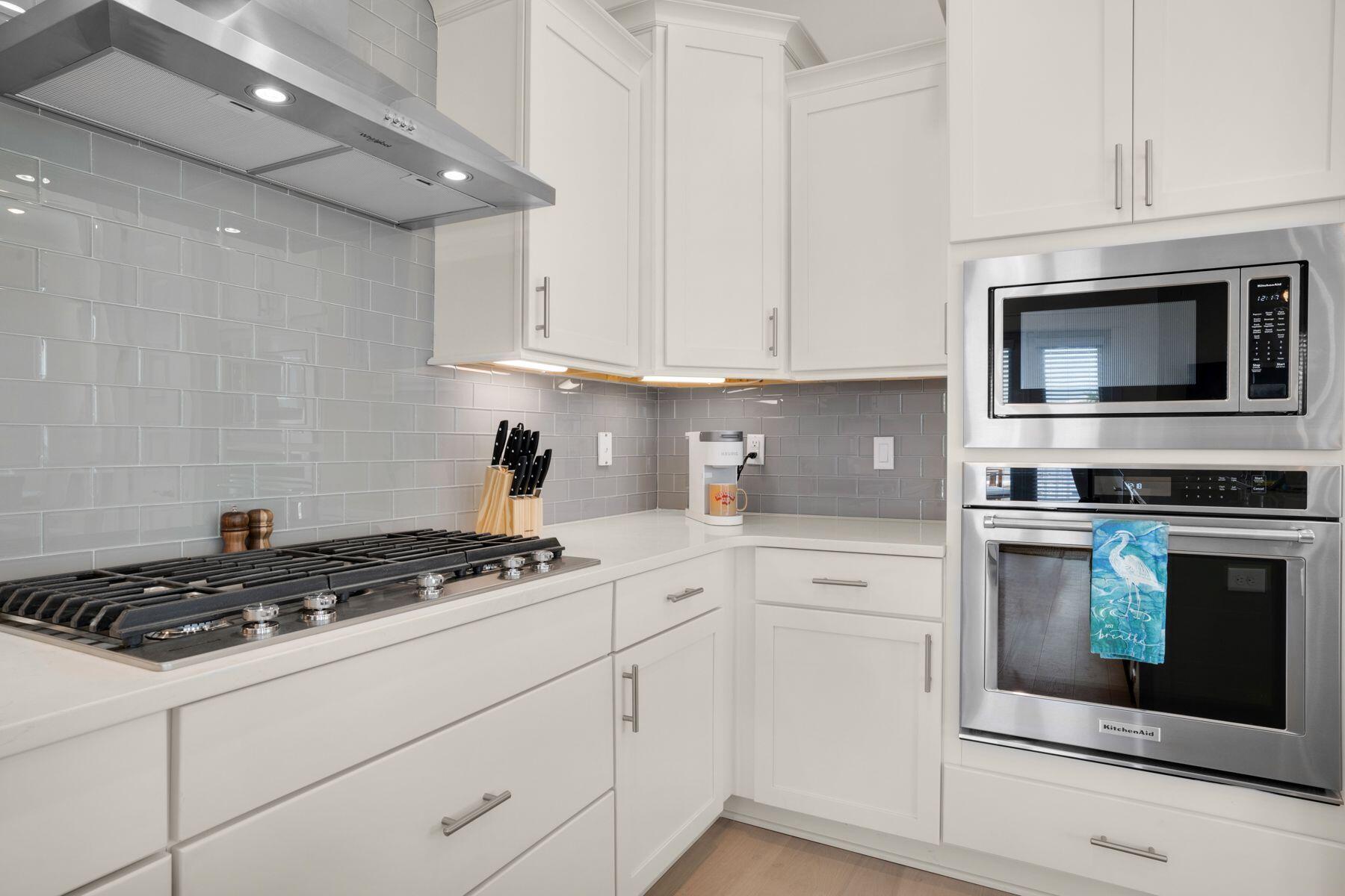110 Wharf Ln Inlet Beach, Unit A Inlet Beach, FL 32461 - Photo 13 of 27 a kitchen with white cabinets and appliances