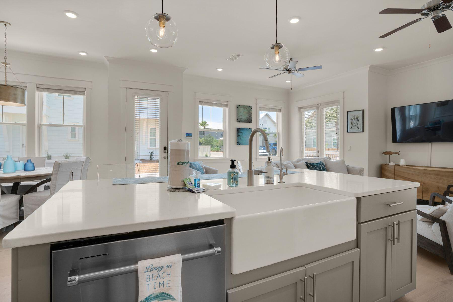 110 Wharf Ln Inlet Beach, Unit A Inlet Beach, FL 32461 - Photo 14 of 27 a kitchen with a sink a stove and chairs