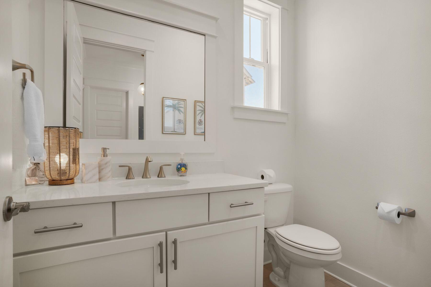 110 Wharf Ln Inlet Beach, Unit A Inlet Beach, FL 32461 - Photo 16 of 27 a bathroom with a toilet sink and mirror
