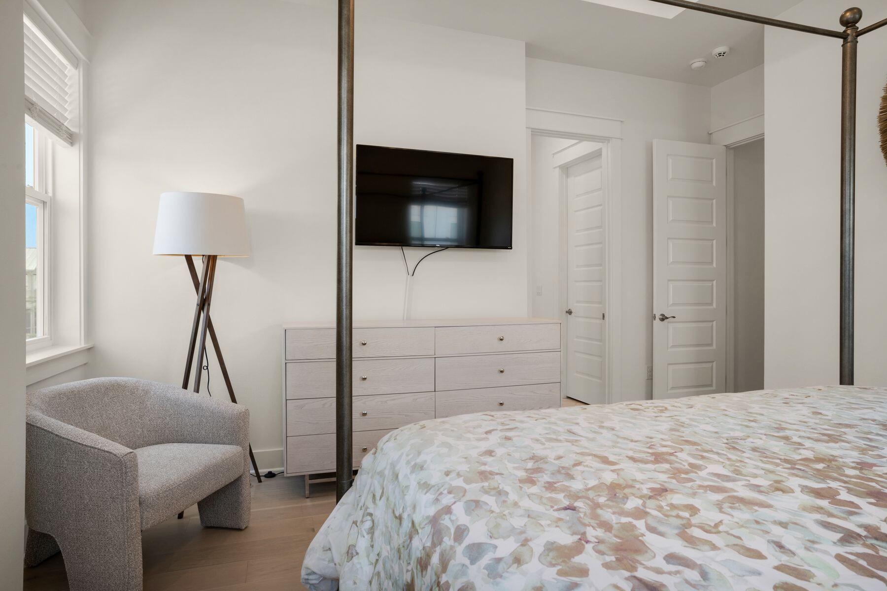 110 Wharf Ln Inlet Beach, Unit A Inlet Beach, FL 32461 - Photo 19 of 27 a bedroom with a bed and a flat screen tv