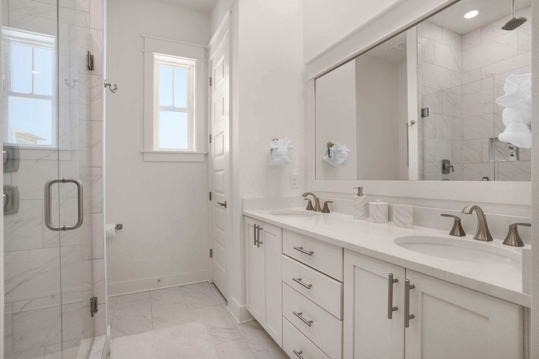 110 Wharf Ln Inlet Beach, Unit A Inlet Beach, FL 32461 - Photo 20 of 27 a bathroom with double sink a two mirror and shower