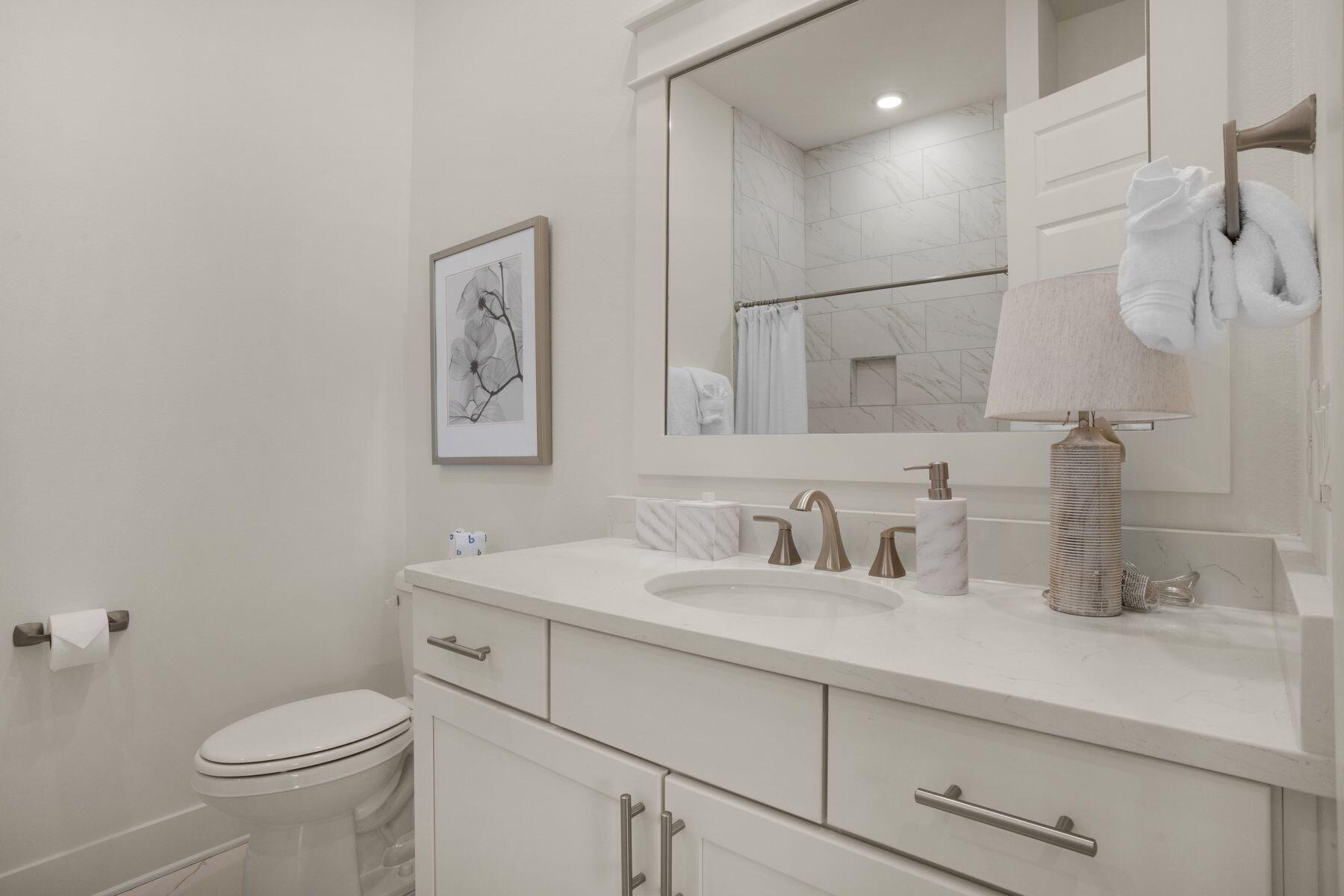 110 Wharf Ln Inlet Beach, Unit A Inlet Beach, FL 32461 - Photo 23 of 27 a bathroom with a sink toilet and vanity