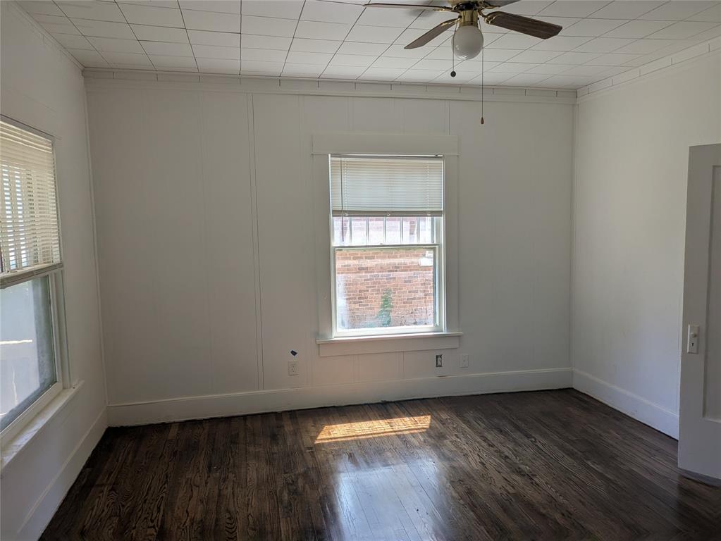1805 11th Street Wichita Falls, TX 76301 - Photo 2 of 14 an empty room with a window and wooden floor