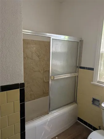 a bathroom with a shower and a toilet