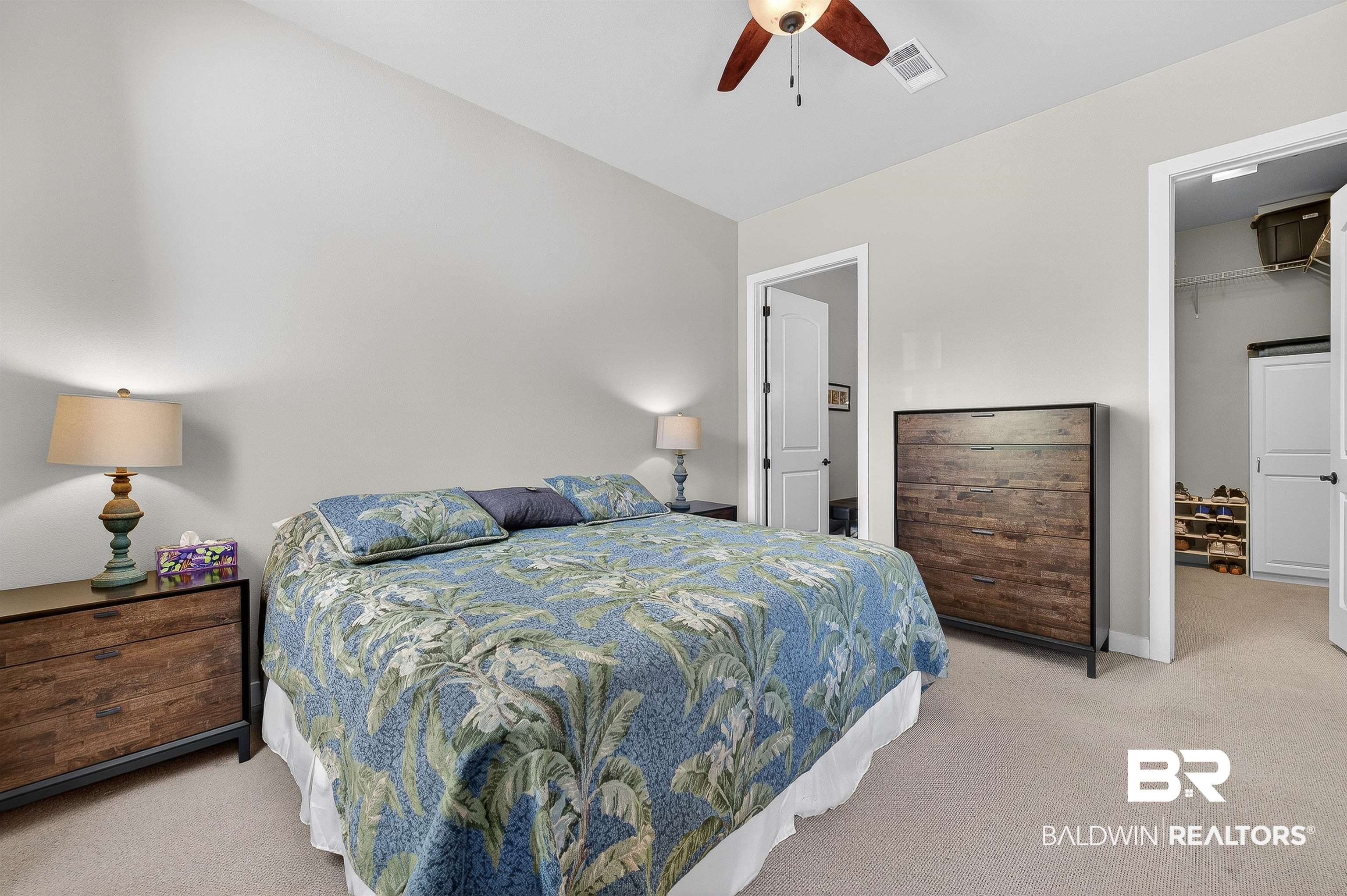 1430 West Regency Road, Unit I102 Gulf Shores, AL 36542 - Photo 13 of 31 Bedroom with light colored carpet, a spacious closet, and a ceiling fan