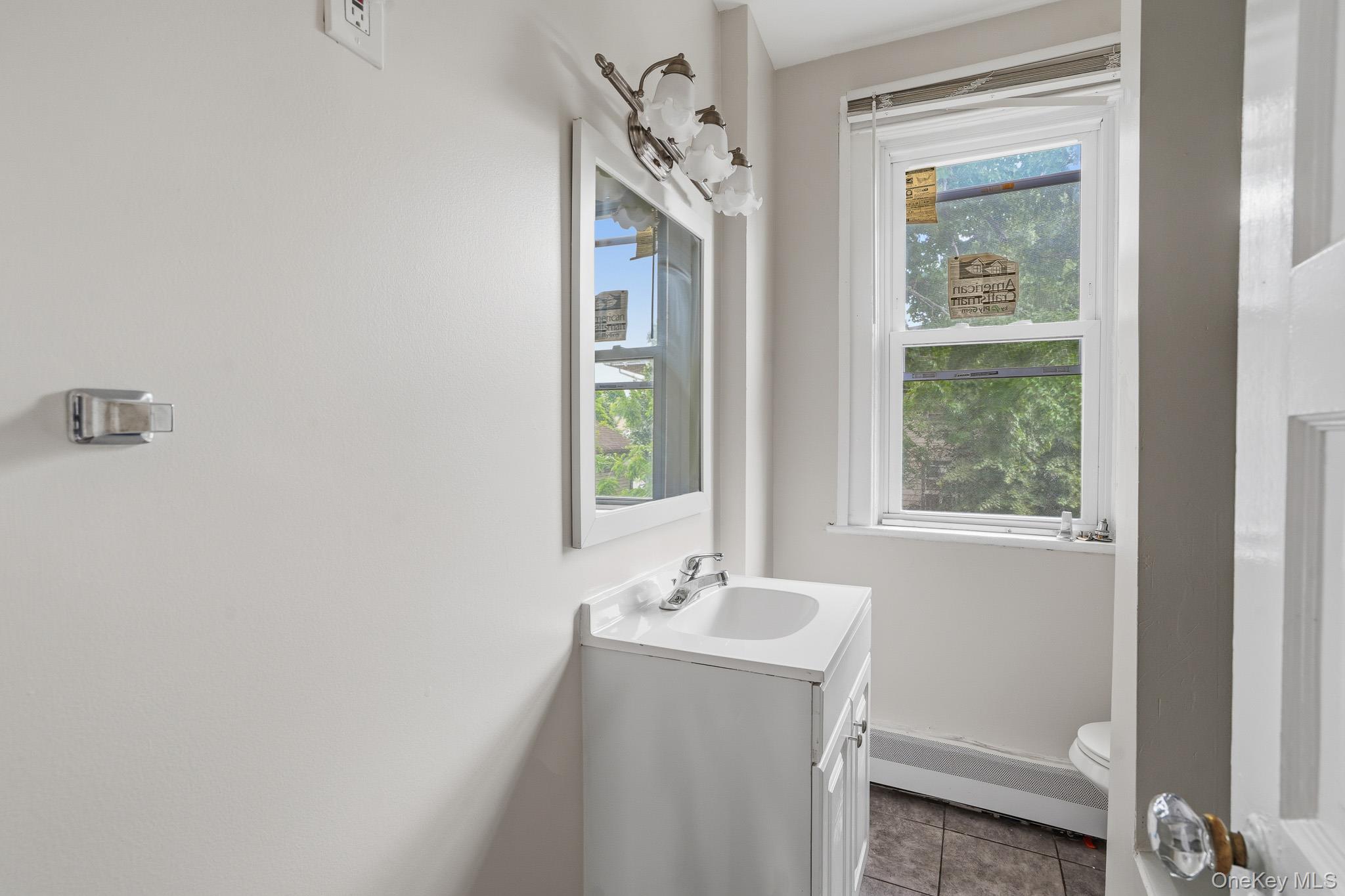65 North Clinton Street Poughkeepsie, NY 12601 - Photo 24 of 43 a bathroom with a bathtub a mirror and a window