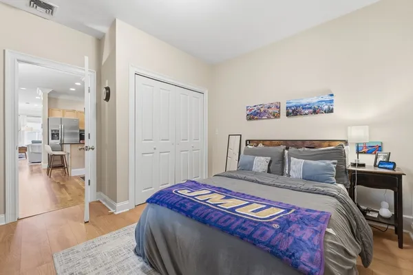 a bedroom with a bed and a view of living room