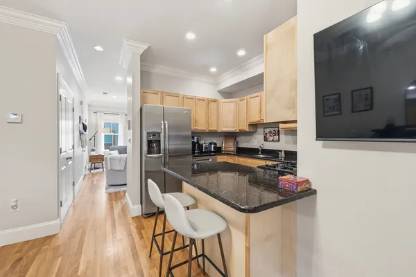 a kitchen with granite countertop a counter space stainless steel appliances and cabinets