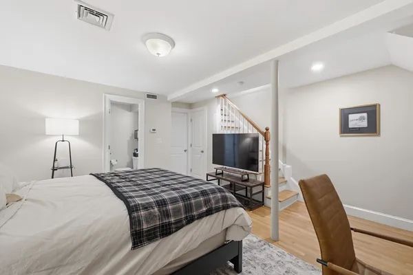 a bedroom with a bed and a flat screen tv