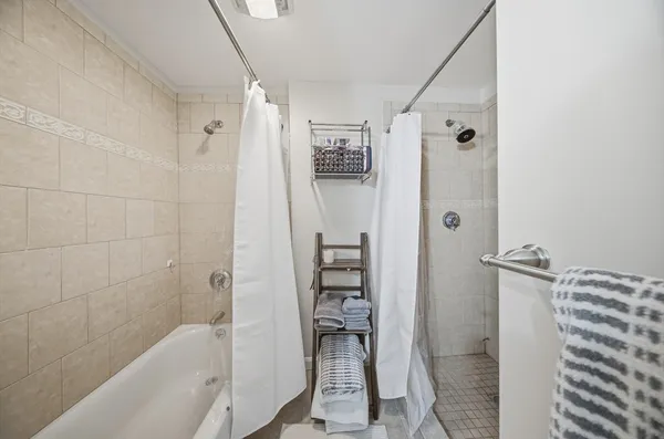 a bathroom with a bathtub and a shower