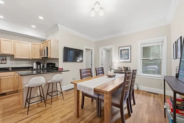 a view of a dining room with furniture and wooden floor