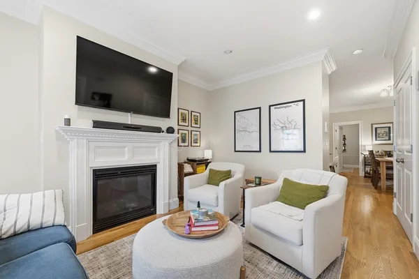 a living room with furniture a flat screen tv and a fireplace