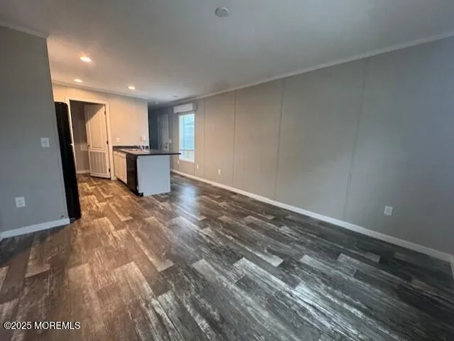 a view of a room with wooden floor and a window