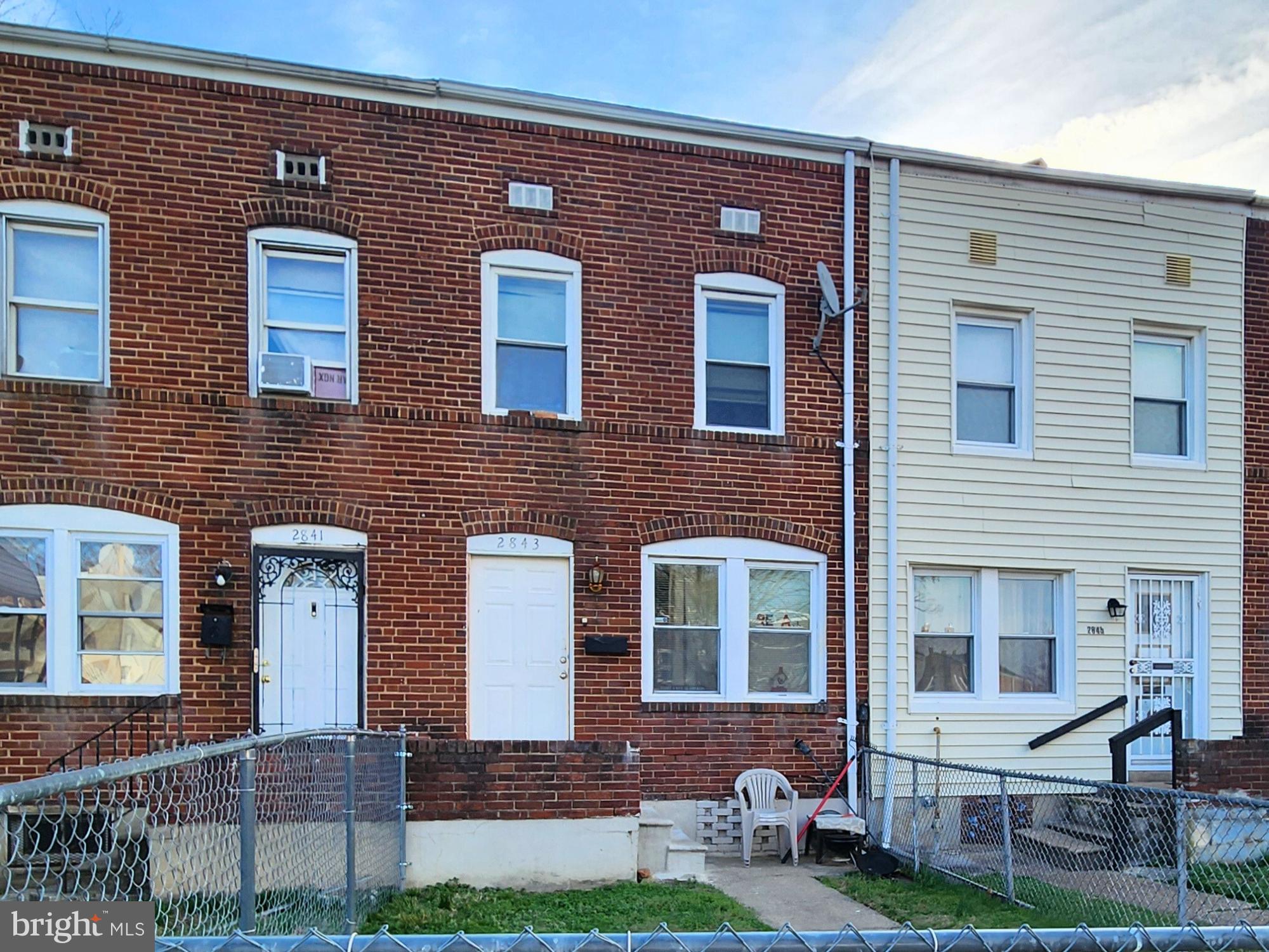 2843 Bookert Drive Baltimore, MD 21225 - Photo 1 of 17 a front view of a house with yard and outdoor seating