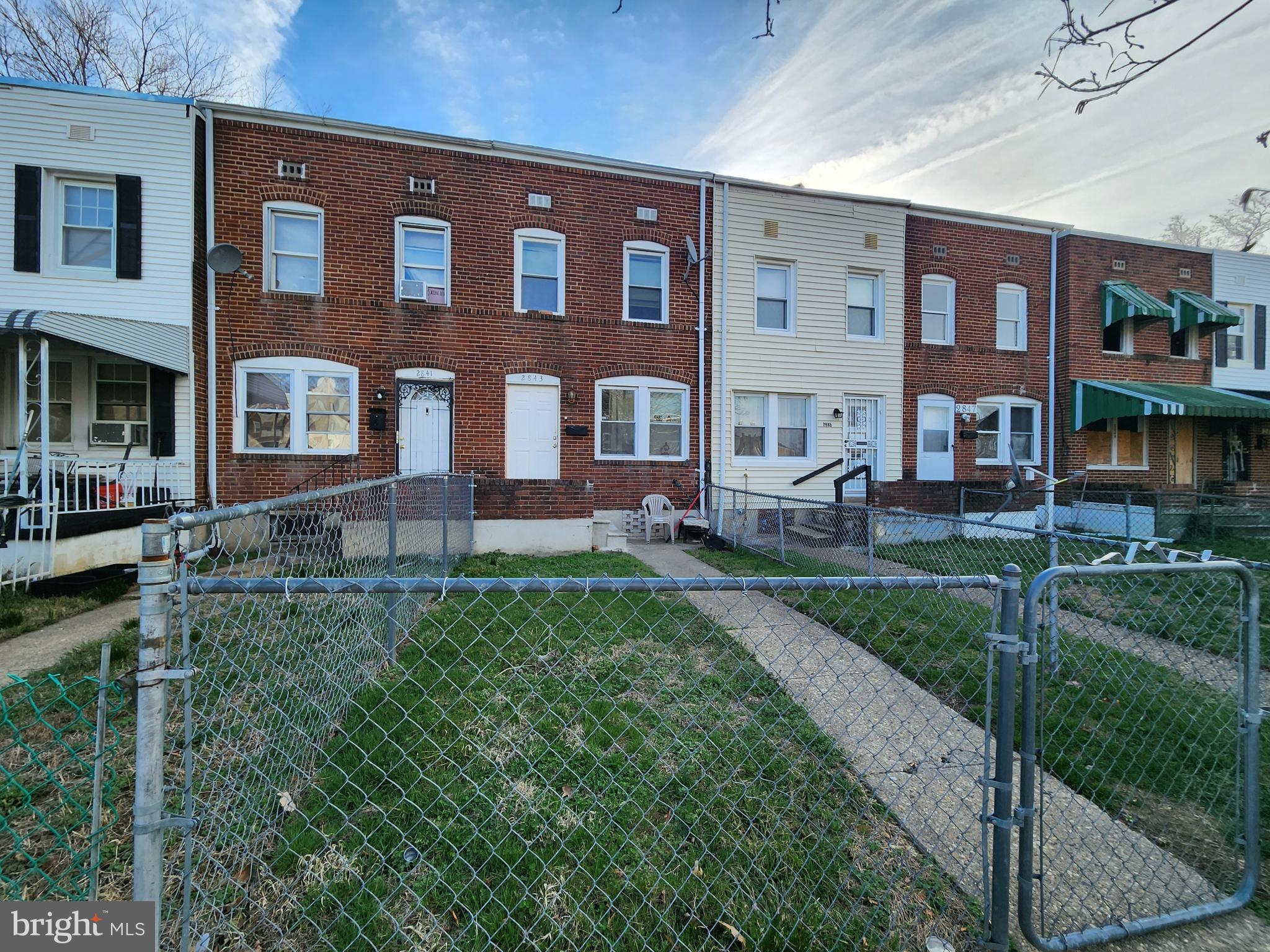 2843 Bookert Drive Baltimore, MD 21225 - Photo 2 of 17 a front view of a building with garden