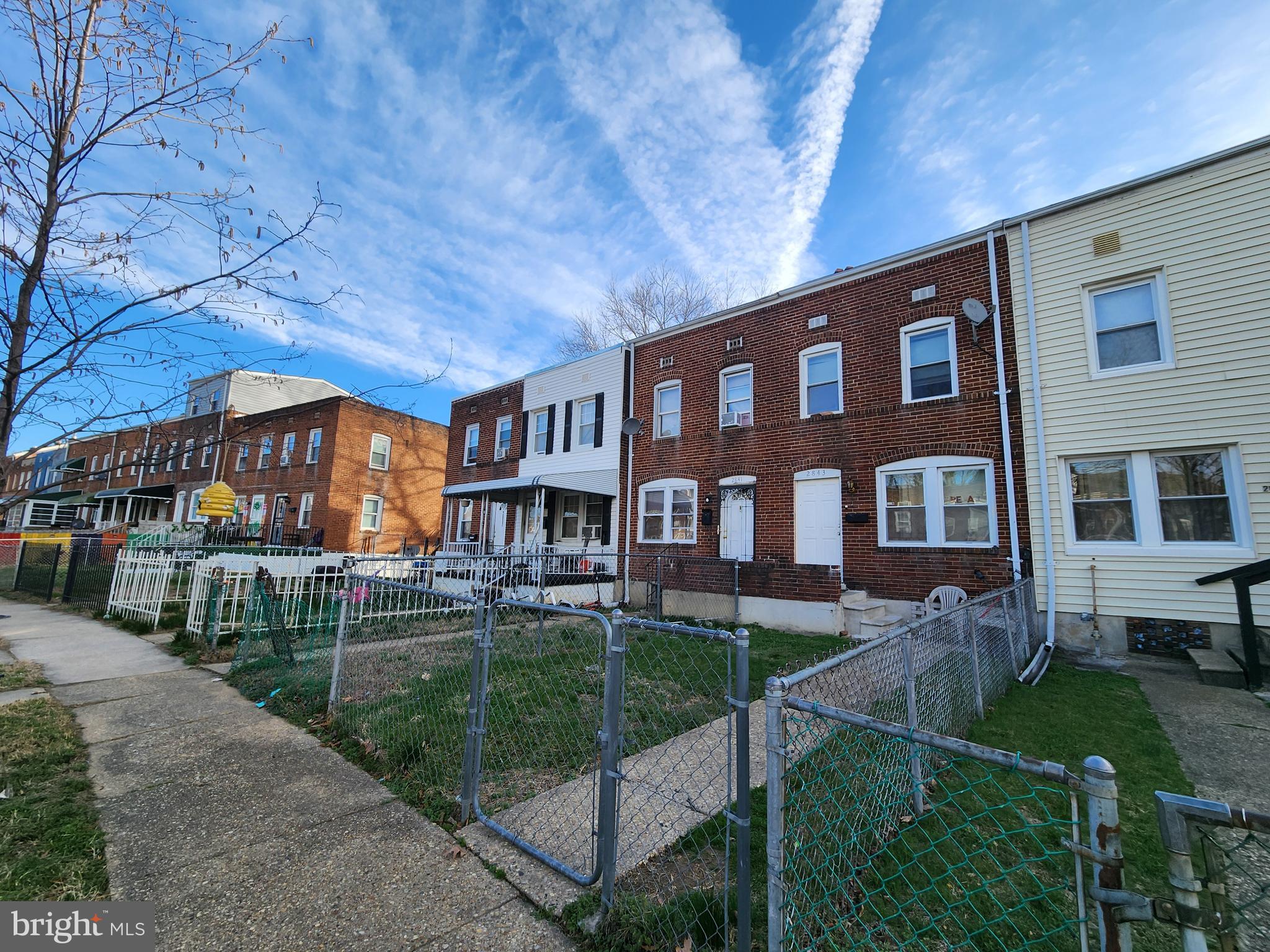 2843 Bookert Drive Baltimore, MD 21225 - Photo 4 of 17 a front view of a house with a yard table and chairs