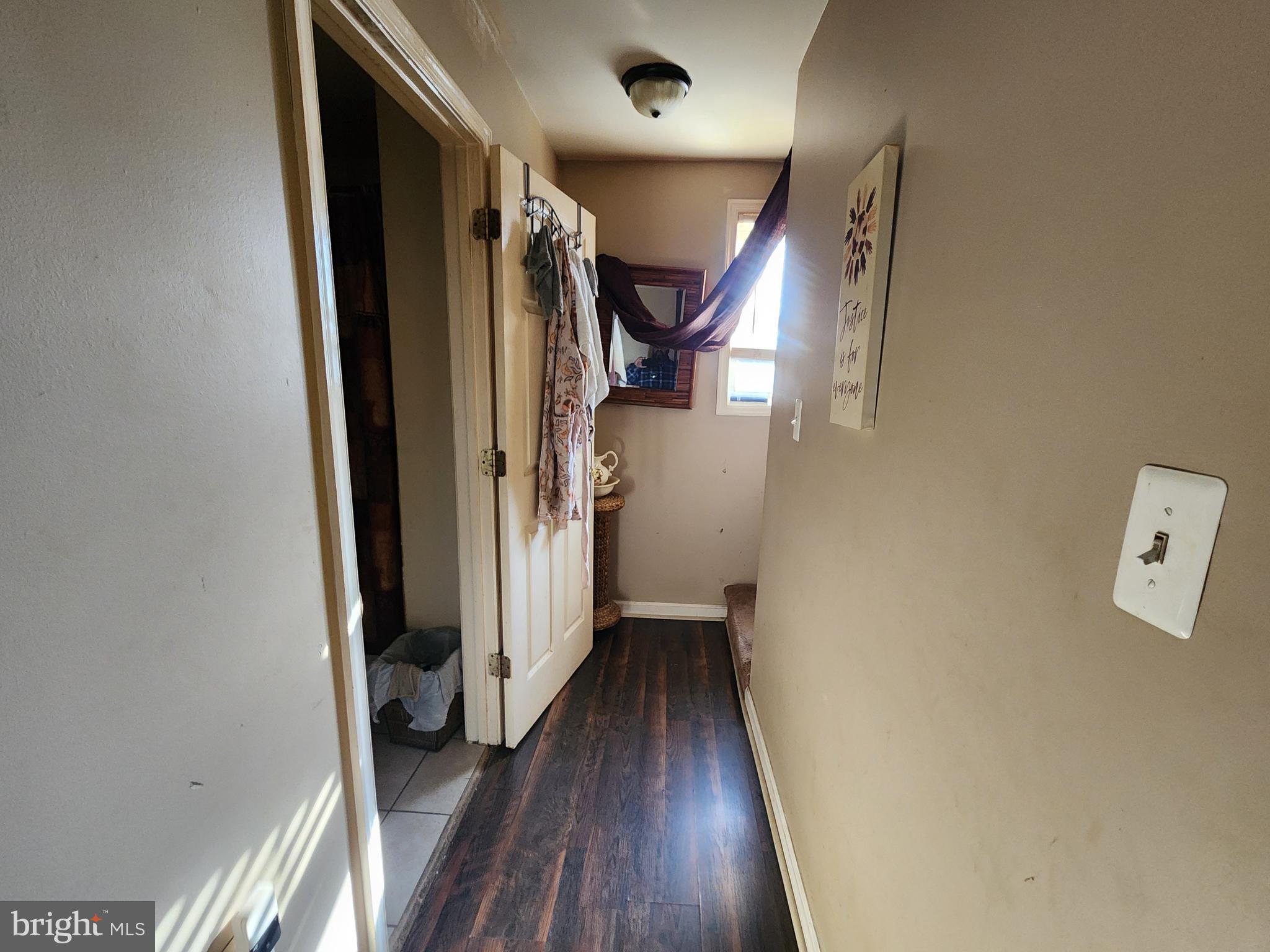 2843 Bookert Drive Baltimore, MD 21225 - Photo 7 of 17 a view of hallway with stairs and wooden floor