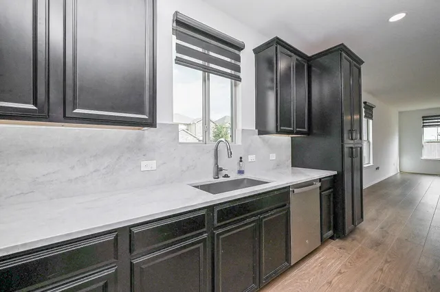 a kitchen with a sink and a refrigerator