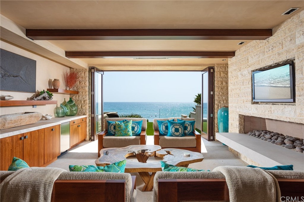 33 Strand Beach Drive Dana Point, CA 92629 - Photo 38 of 54 a living room with patio furniture and a floor to ceiling window