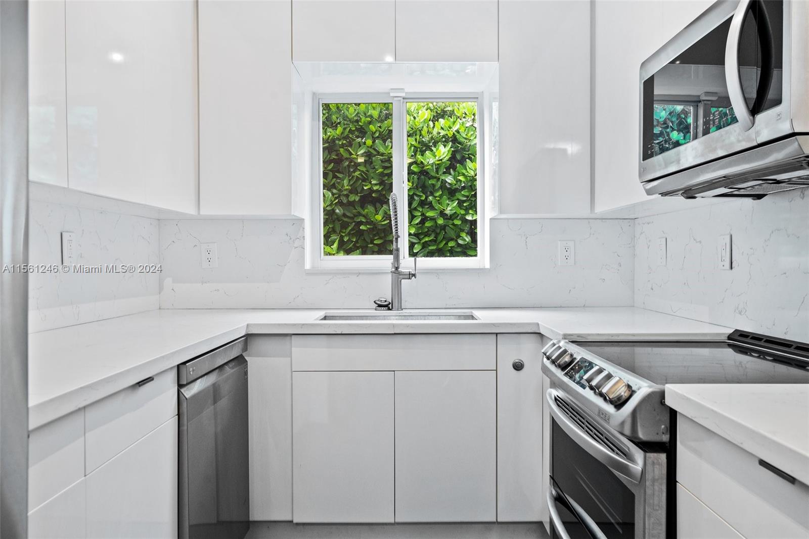 2733 Southwest 15th Street Miami, FL 33145 - Photo 12 of 34 a kitchen with a sink stove and cabinets