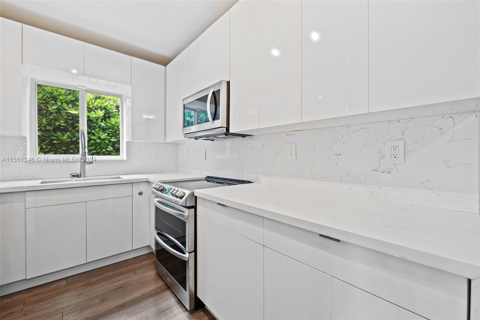 2733 Southwest 15th Street Miami, FL 33145 - Photo 13 of 34 a kitchen with a stove oven and sink