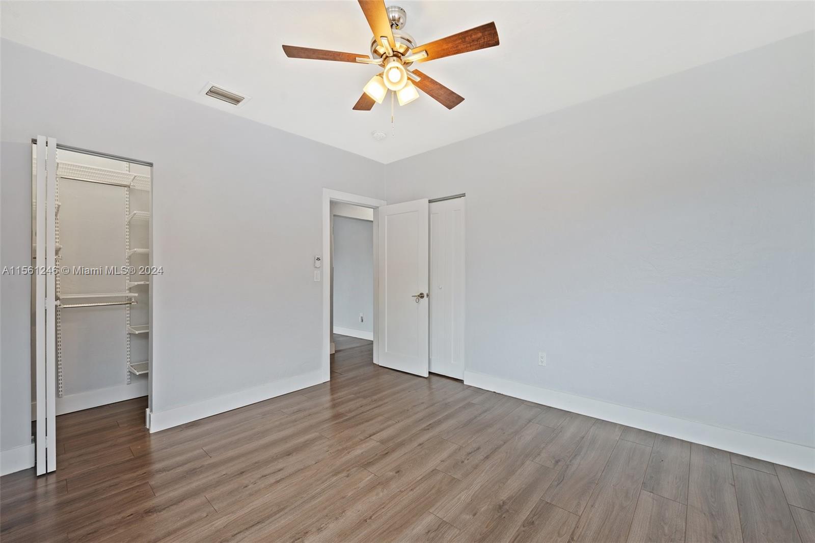 2733 Southwest 15th Street Miami, FL 33145 - Photo 22 of 34 an empty room with wooden floor and a ceiling fan