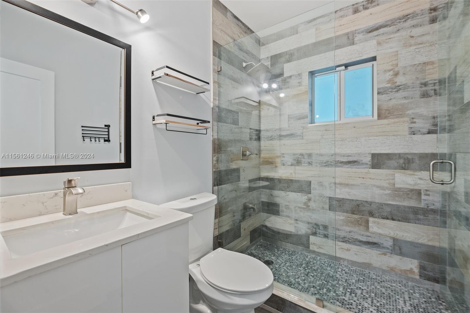 2733 Southwest 15th Street Miami, FL 33145 - Photo 23 of 34 a bathroom with a sink a toilet and shower