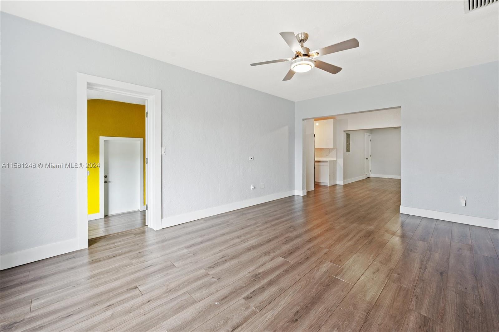 2733 Southwest 15th Street Miami, FL 33145 - Photo 7 of 34 a view of an empty room with wooden floor and a ceiling fan