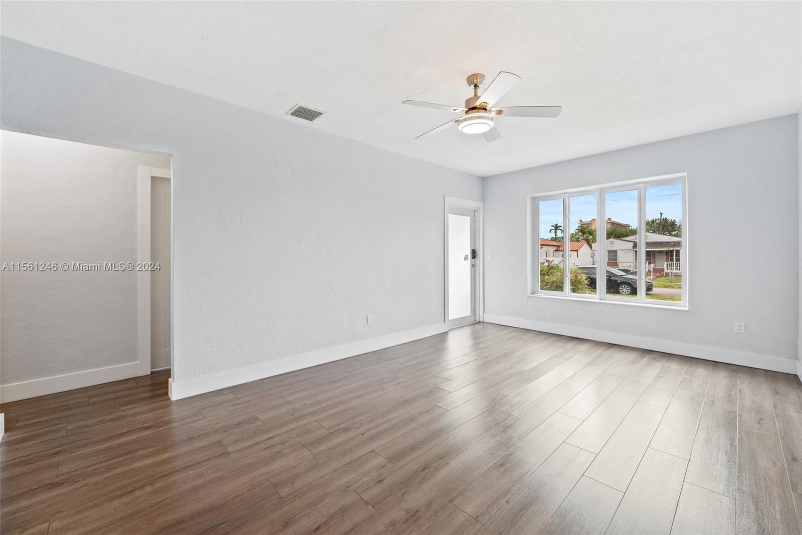 2733 Southwest 15th Street Miami, FL 33145 - Photo 8 of 34 a view of an empty room with wooden floor and a window