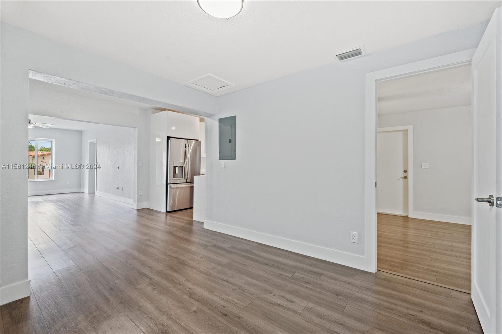 2733 Southwest 15th Street Miami, FL 33145 - Photo 10 of 34 a view of an empty room with wooden floor and a window