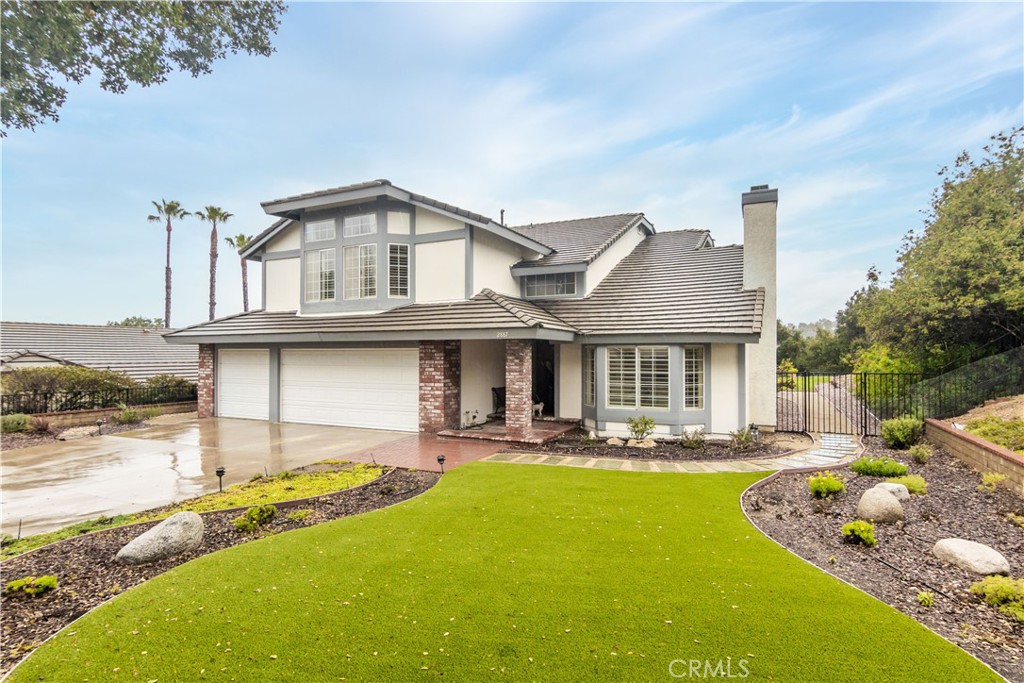 a front view of a house with swimming pool yard and patio