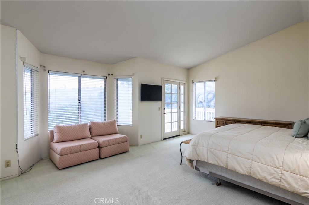 2887 Queens Way Thousand Oaks, CA 91362 - Photo 24 of 35 a bedroom with a bed flat screen tv and a large window