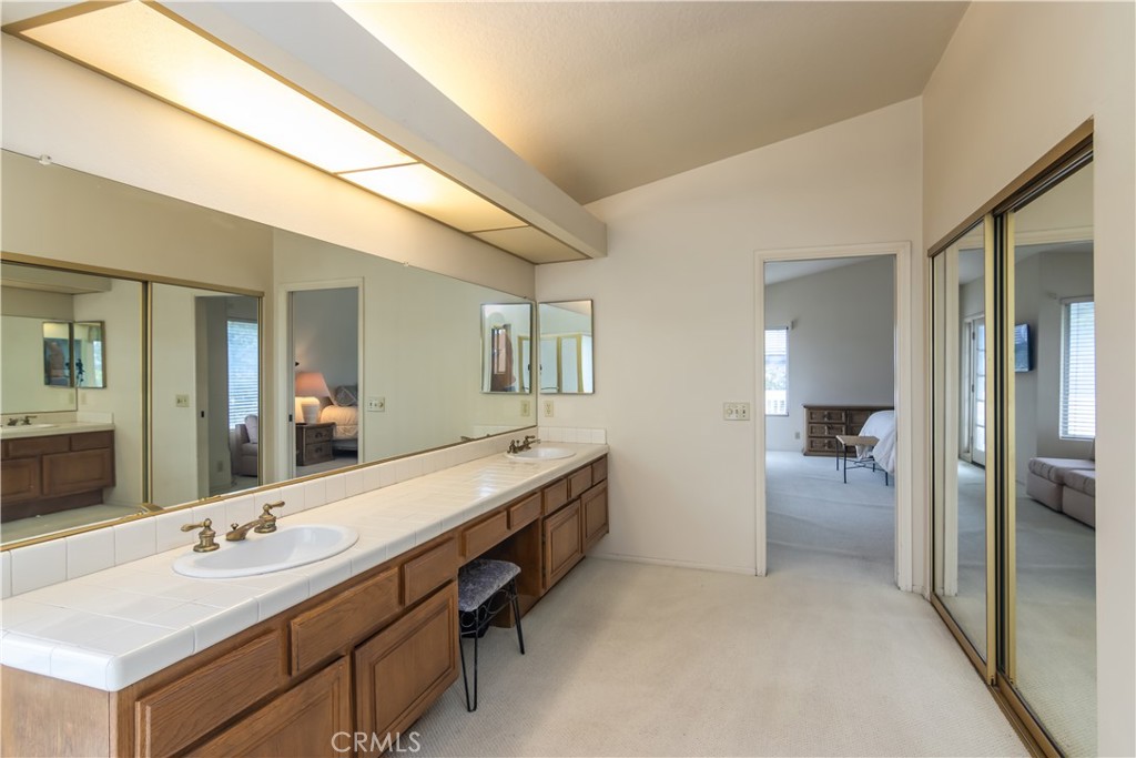 2887 Queens Way Thousand Oaks, CA 91362 - Photo 26 of 35 a bathroom with a granite countertop sink and a mirror
