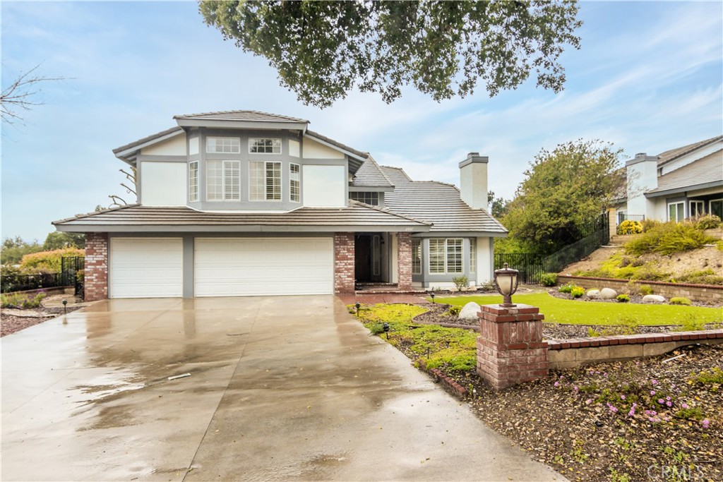 2887 Queens Way Thousand Oaks, CA 91362 - Photo 3 of 35 a front view of a house with a yard and garage