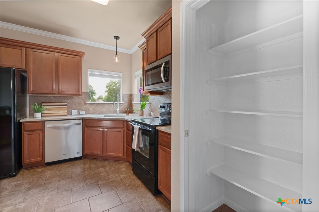 408 Copper Ridge Loop Temple, TX 76502 - Photo 17 of 39 Kitchen view highlighting the pantry storage