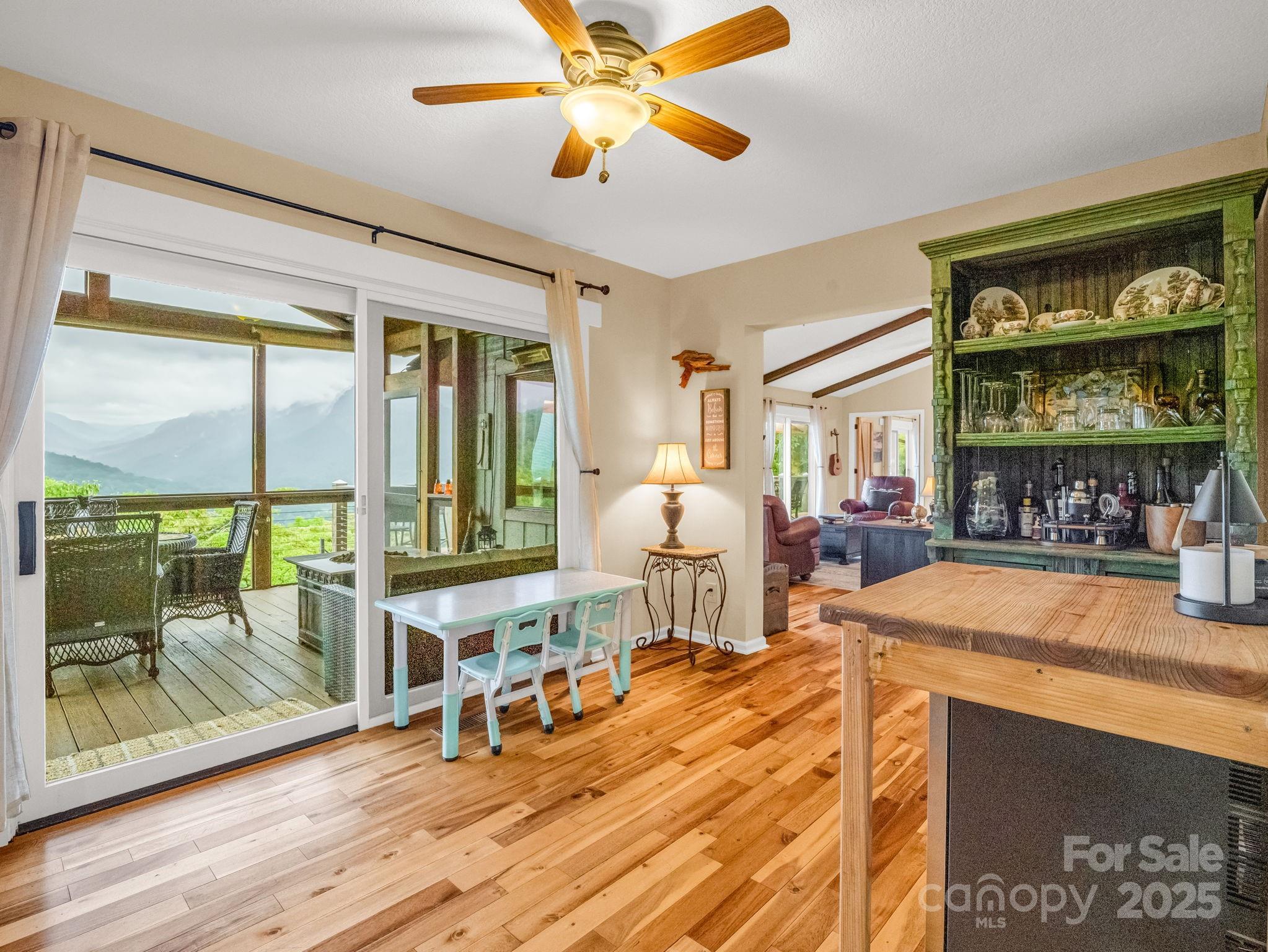 315 Thomas A Edison Rd Lake Lake Lure, NC 28746 - Photo 13 of 47 a living room with furniture a flat screen tv and floor to ceiling window