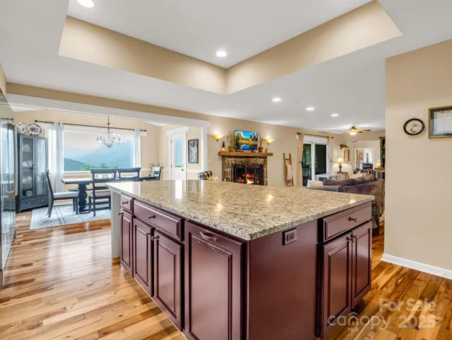 a kitchen with stainless steel appliances granite countertop a kitchen island a stove and a sink