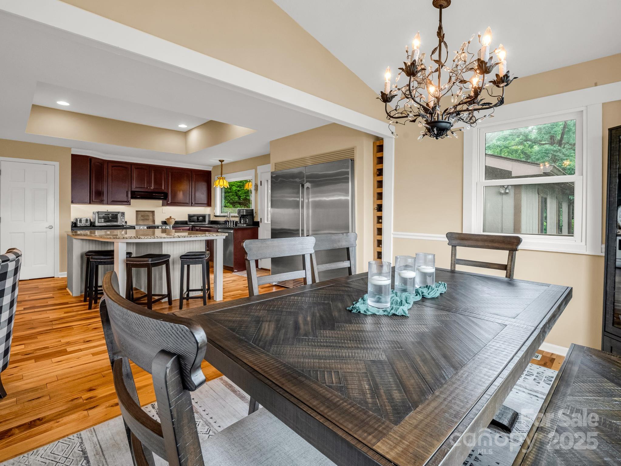 315 Thomas A Edison Rd Lake Lake Lure, NC 28746 - Photo 17 of 47 a view of a dining room with furniture a chandelier and wooden floor