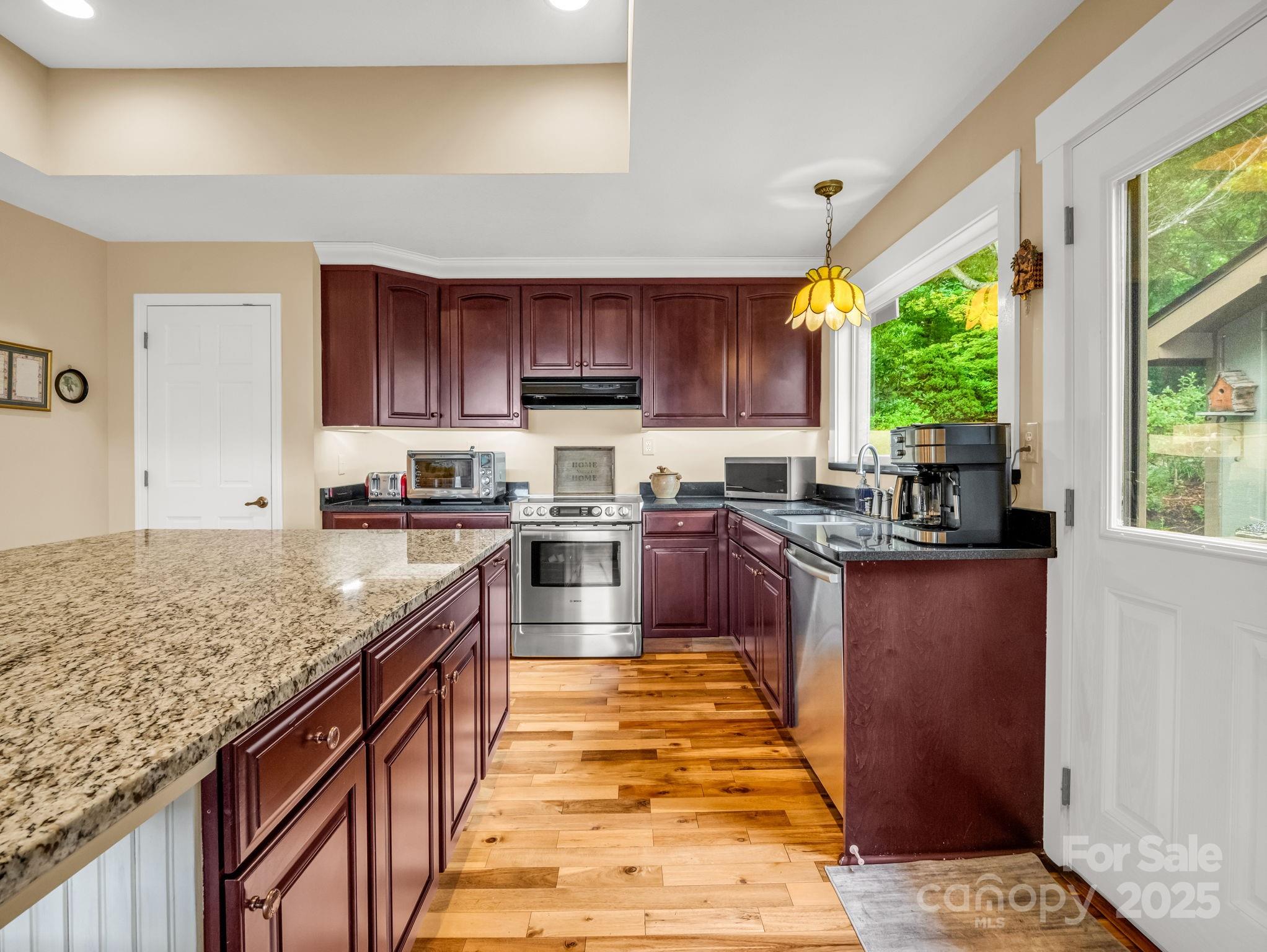 315 Thomas A Edison Rd Lake Lake Lure, NC 28746 - Photo 21 of 47 a kitchen with stainless steel appliances granite countertop a stove a sink and a microwave