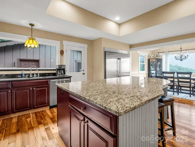a kitchen with stainless steel appliances granite countertop a stove and a sink